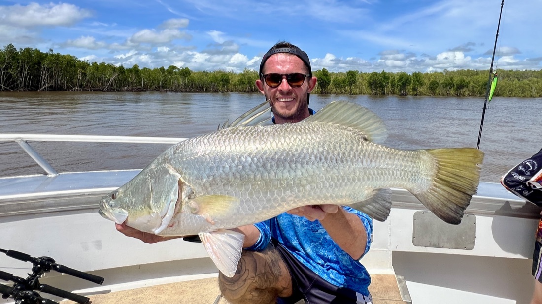 Angler with a barramundi caught on a Cape Adieu Top End estuary fishing charter
