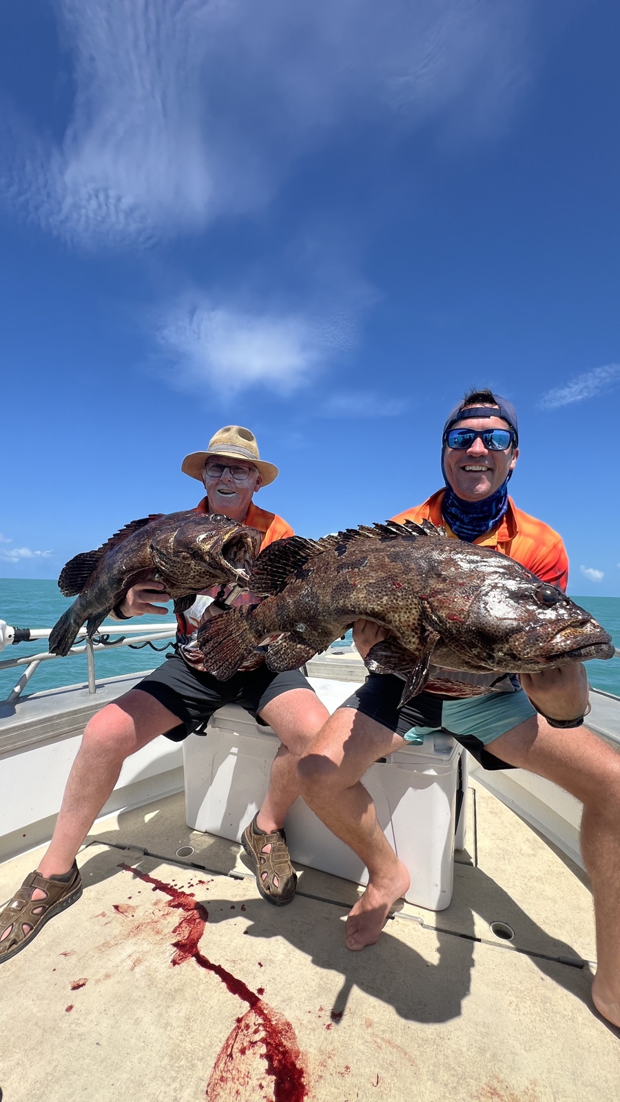 Two anglers with estuary cod caught on a Darwin harbour fishing charter