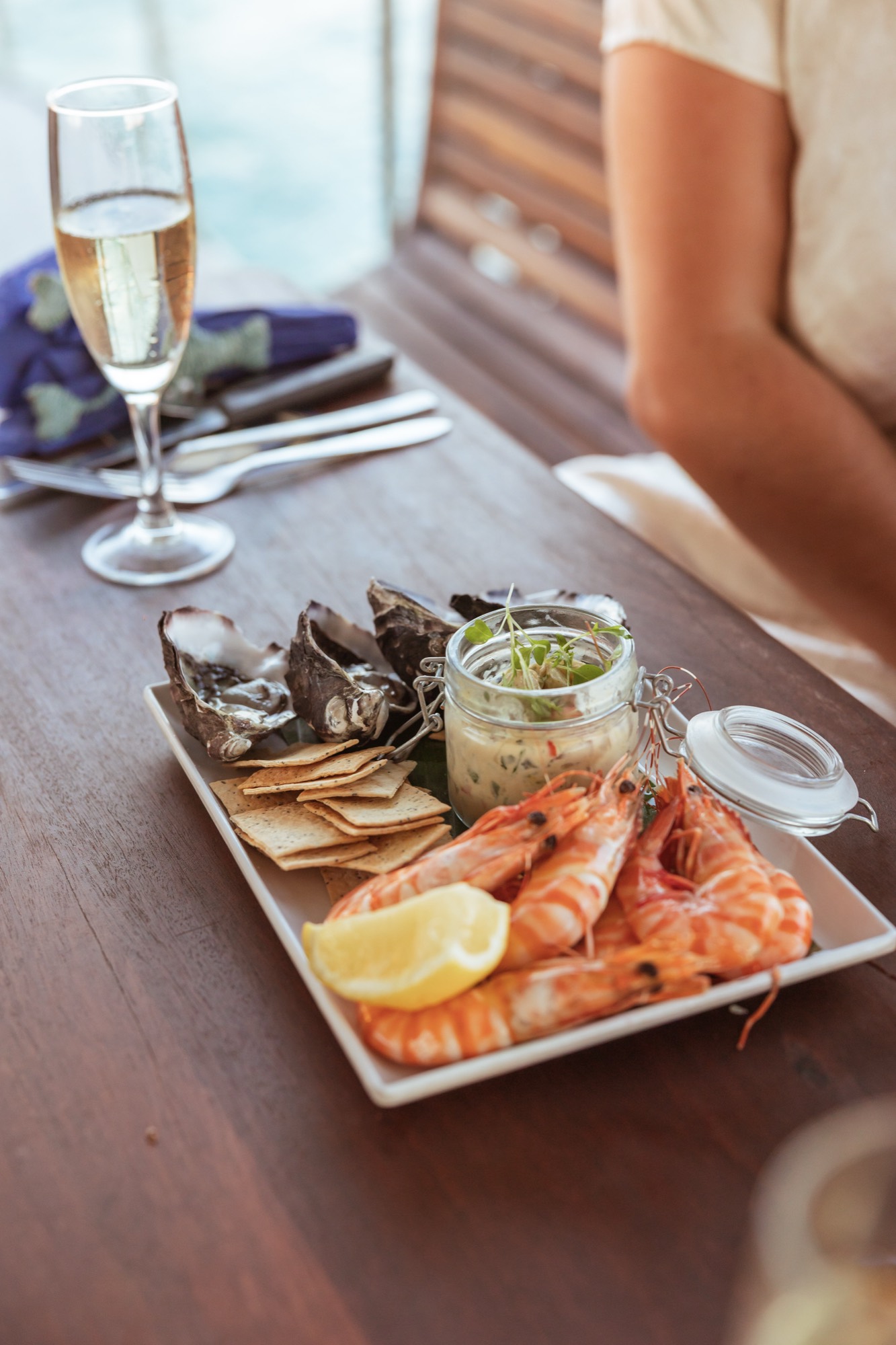 A prawn platter and champagne set out on the deck of a Darwin sundowner cruise